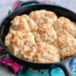 a big cast iron skillet filled with cathead biscuits