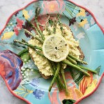 Egg Salad with asparagus on whole wheat toast topped with lemons