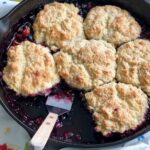 blueberry peach cobbler in a cast iron skillet