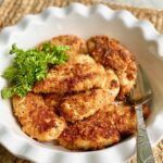 crunchy parmesan chicken in a serving dish