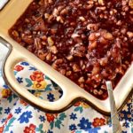 cranberry pecan salad on a floral napkin with pecans, pineapple and cranberries