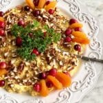 bacon apricot cheese spread on a white plate with parsley and apricot garnish