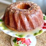 coconut rum cake on a cake plate.