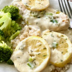 Lemon Butter Chicken on a plate with broccoli and rice