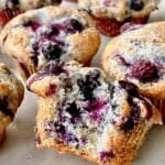 Blueberry Muffins bursting open with extra blueberries inside.