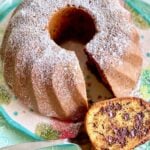 double chocolate chip bundt cake on a teal floral plate with a slice cut out