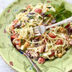 swirl of garden spaghetti salad wrapped around a fork with pasta underneath