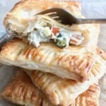 chicken pot hand pies with a fork taking a bite on the top