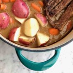 pot roast in a blue dutch oven