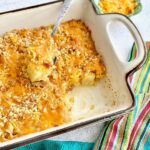 pineapple cheese casserole being served with a spoon.