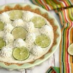 the perfect key lime pie that's no bake and topped with limes and whipped cream.