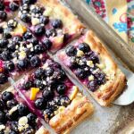 slice of blueberry lemon pastry served with a cake server.