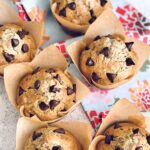 zucchini chocolate chip muffins on a floral towel.