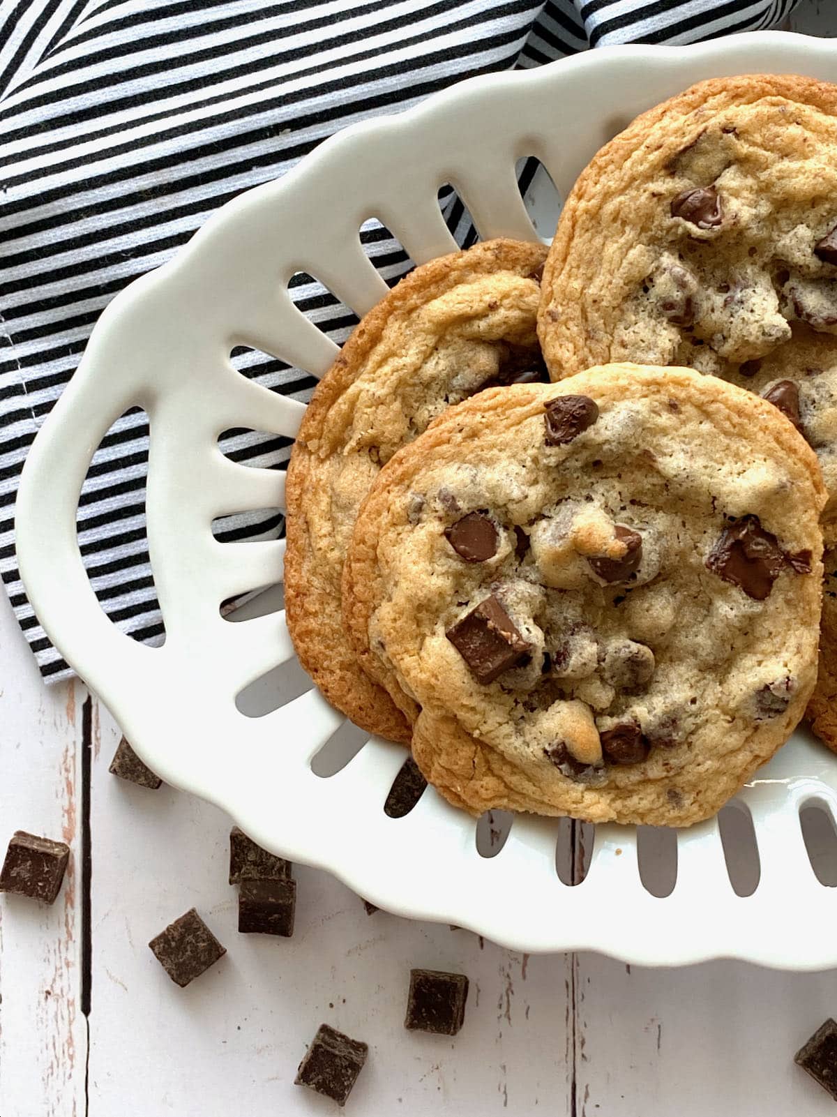 bowl of chocolate chip cookies on a black and white napkin.