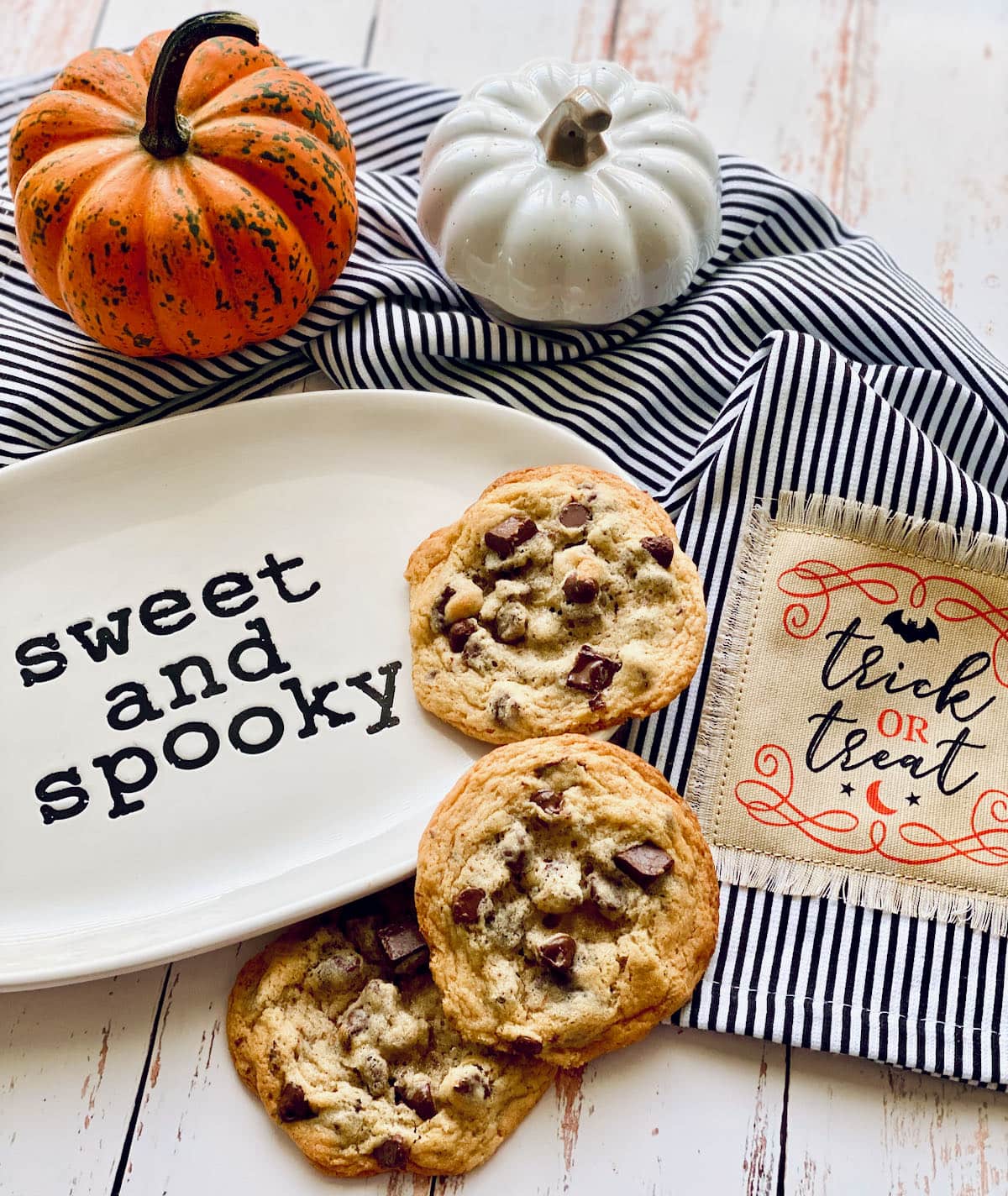 chocolate chip cookies on a plate that says sweet and spooky.