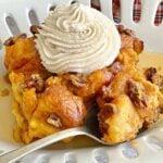 bread pudding made with pumpkin and brioche on a white scalloped dish.
