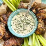 air fryer chicken wings with celery sticks and blue cheese dip.