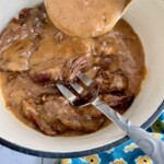 pot roast in a dutch oven with gravy.