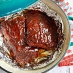 baby back barbecue ribs on foil in a dutch oven.