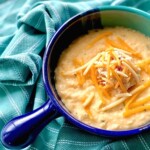 cheesy grits topped with a scoop of pimento cheese in a blue bowl.