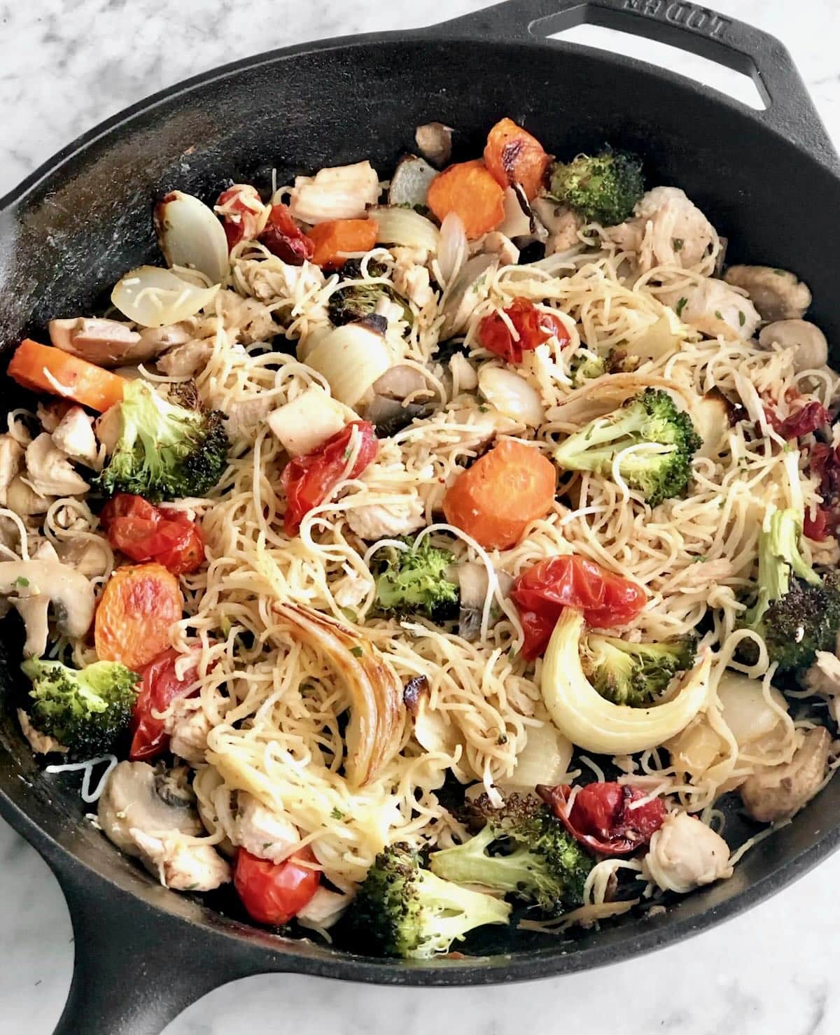 veggies and pasta in a cast iron skillet.