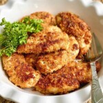 chicken tenders made with parmesan and panko in a white dish.