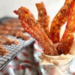 strips of million dollar bacon in a glass.