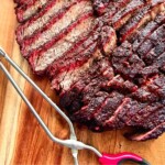 sliced smoked chuck roast on a cutting board.