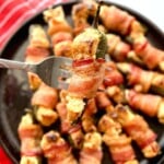 smoked jalapeño popper being held up by a fork.