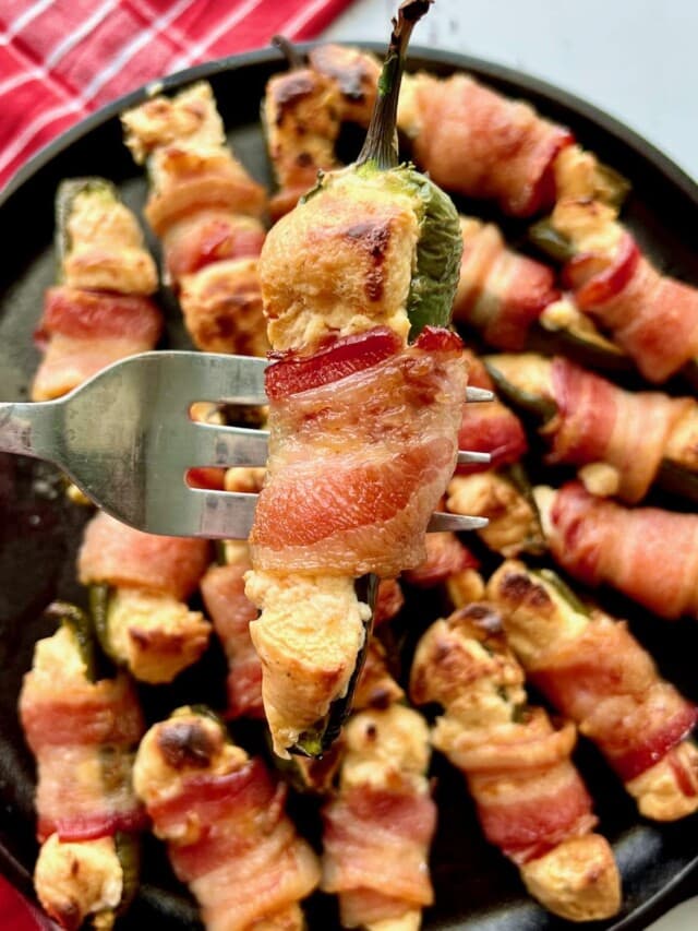 jalapeño poppers being held up by a fork.