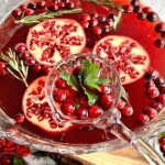 ladle filled with Christmas punch being served into glasses.