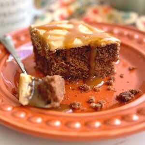 slice of salted caramel chocolate cake with a drizzle of caramel on the plate.