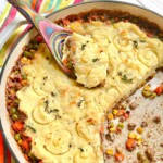 Shepherd's Pie being served from a dutch oven with a colorful spoon.