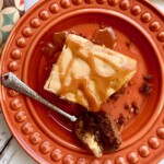 slice of salted caramel chocolate cake on an orange plate.