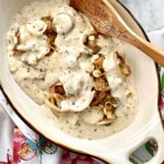 country style steak and white cream gravy in a casserole dish.