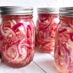 sweet pickled onions packed in pint size mason jars.