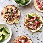 carnitas taco bar menu with onions, pulled pork, cilantro and limes.
