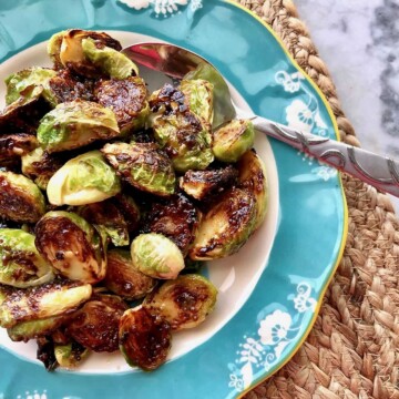bowl of caramelized brussels sprouts with a spoon.