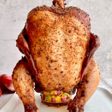 Smoked Beer Can Chicken sitting on a beer can after smoking in a Traeger pellet grill.