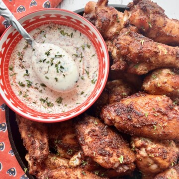 Crispy smoked chicken wings with a bowl of blue cheese dip.