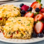 Crescent roll breakfast casserole served with fresh fruit.