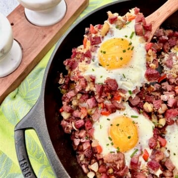 Corned beef hash and eggs in a cast iron skillet.