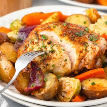Chicken Thigh Tray Bake with potatoes, carrots and Brussels Sprouts.