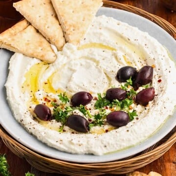 Pita bread in whipped feta dip with kalamata olives.