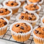 Pumpkin chocolate chip muffins on a wire rack.