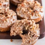 Bite out of a pumpkin spice donut.