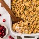 Casserole lifted out of dish with wooden spoon.