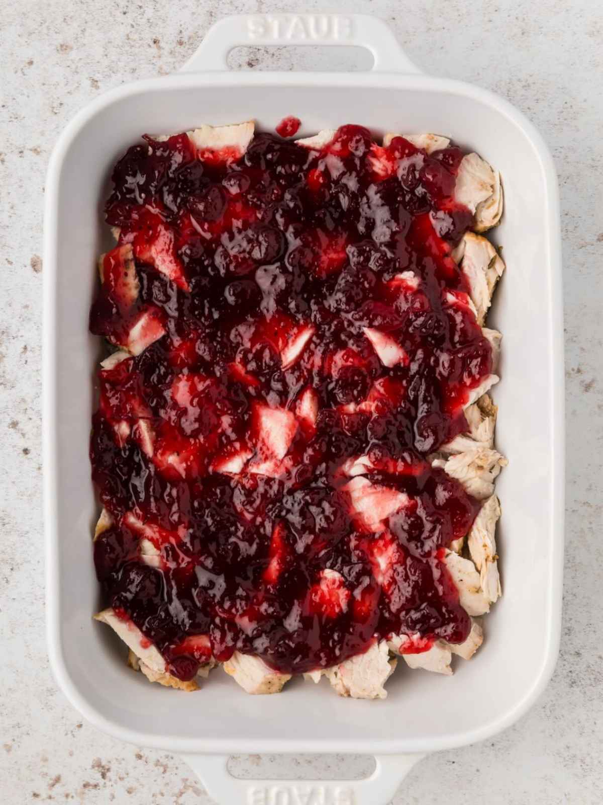 Cranberry sauce layered on top of turkey.