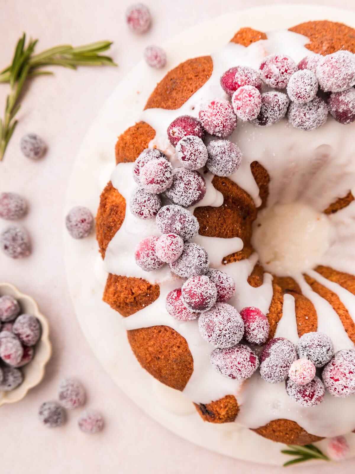 Overhead photo of sugared cranberries on bundt cake.