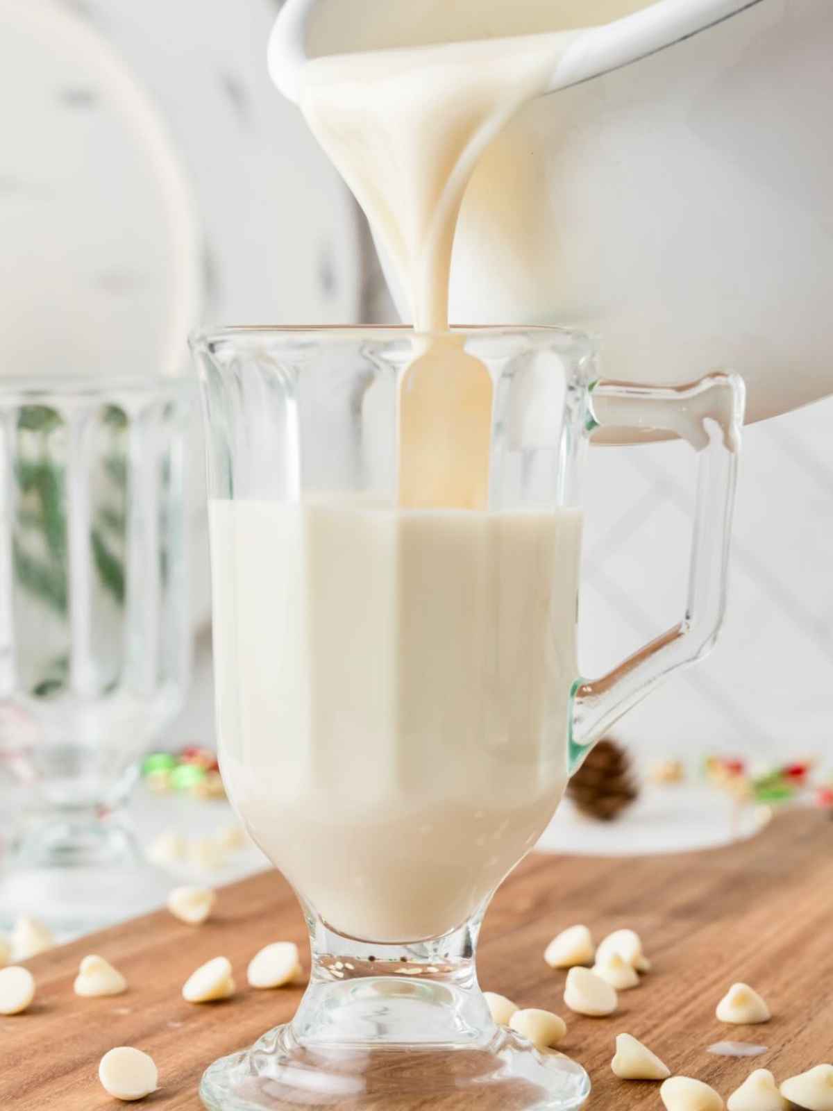 White hot chocolate being poured in a mug.